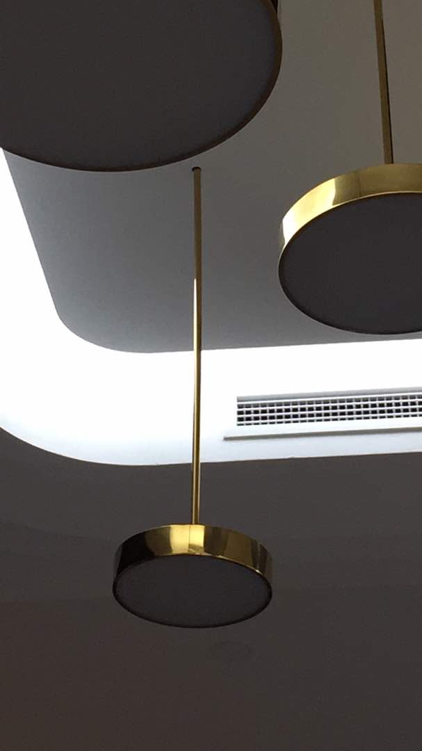 Brass disc pendant — detail