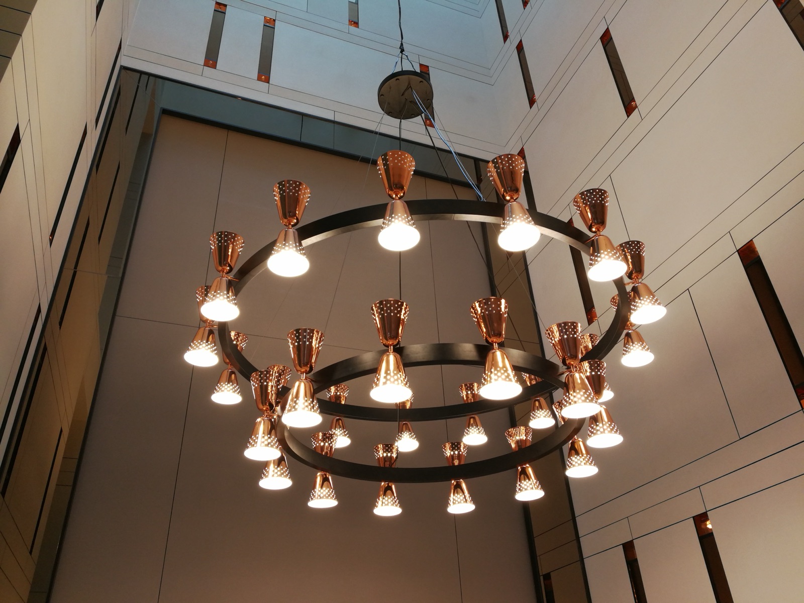 Double-ring copper chandelier — lit